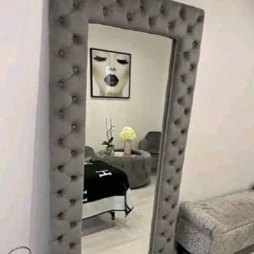Upholstered standing mirror