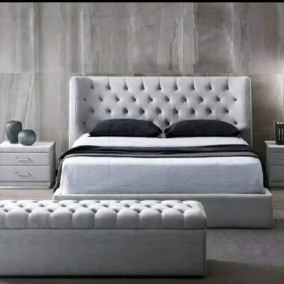 Grey tufted bed